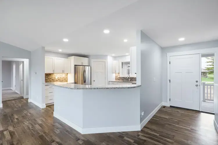 Newly remodeled Clio kitchen featuring granite countertops, white cabinetry, stainless steel refrigerator, and recessed lighting
